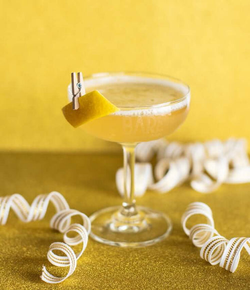 A BARE 75 Zero-Proof Cocktail on a table, made with BARE ZERO PROOF® Modern Classic Gin