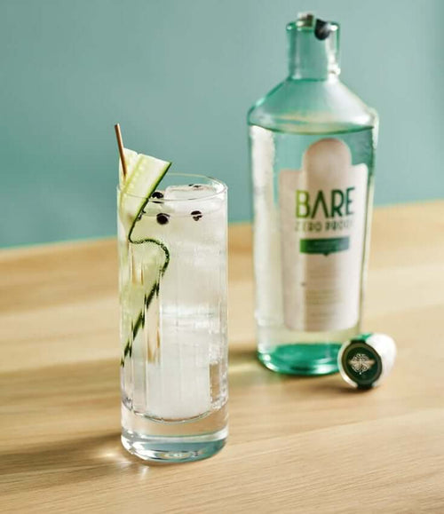 A BARE English G&T Zero-Proof cocktail with a bottle of BARE ZERO PROOF® Modern Classic Gin