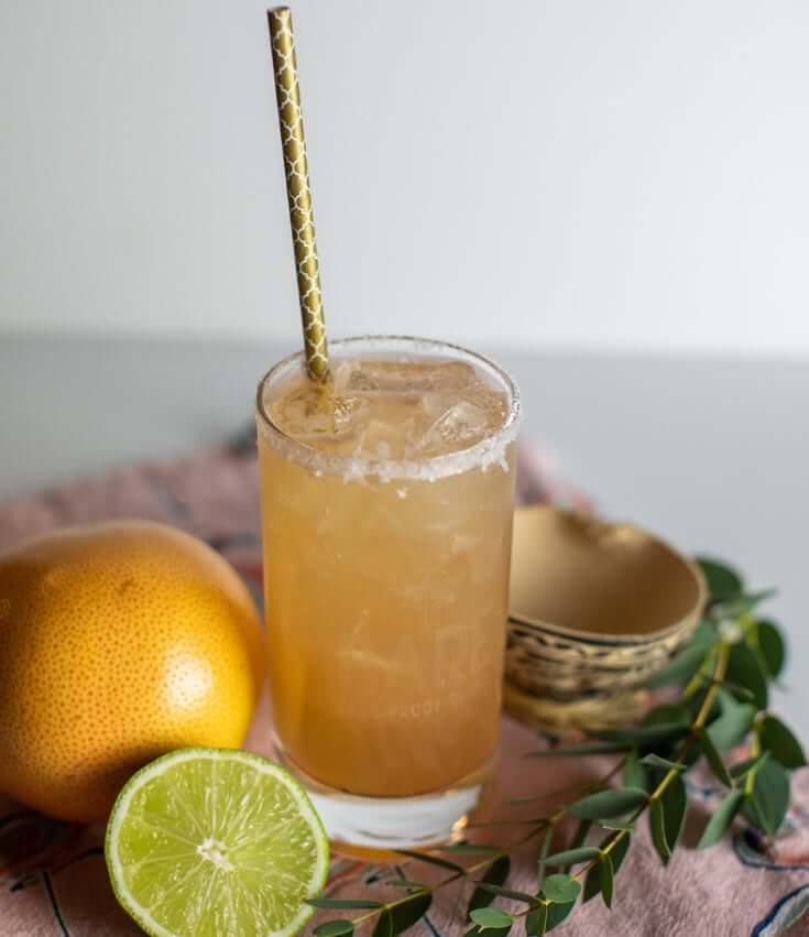 BARE Paloma sin Pantelones Zero-Proof cocktail in a glass on table, made with BARE ZERO PROOF® Reposado Style Tequila